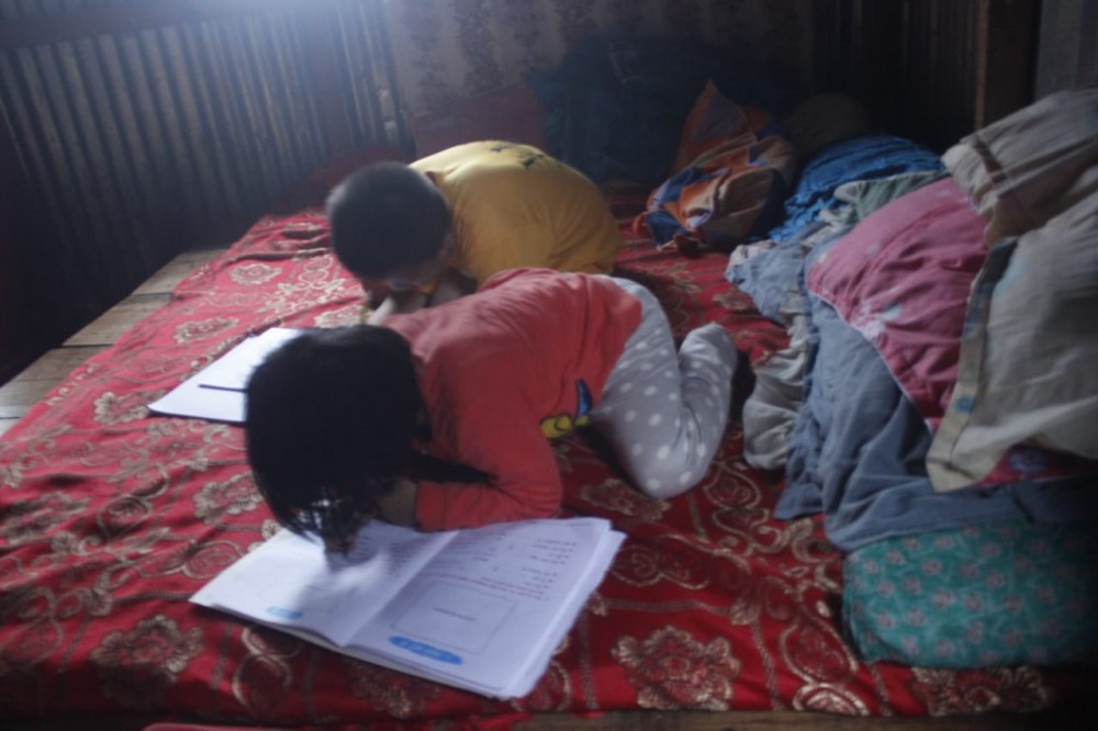 A Class-5 student and a Class-B student doing their homework.The mother of the two siblings also expressed concern over excessive homework while citing that the Class-5 student has homework in all the 8 subjects during this summer vacation. (Morung Photo)